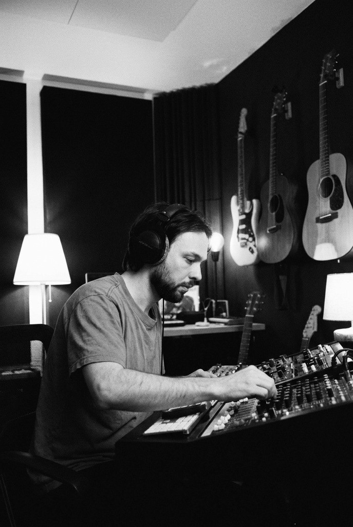 Yahor Milkota working with music equipment in his Warsaw studio